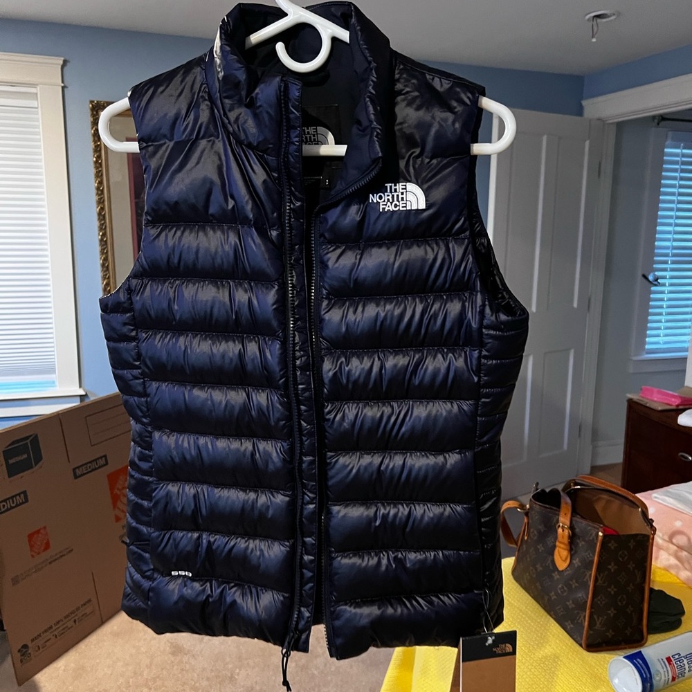 Size small North Face down vest. Brand new.